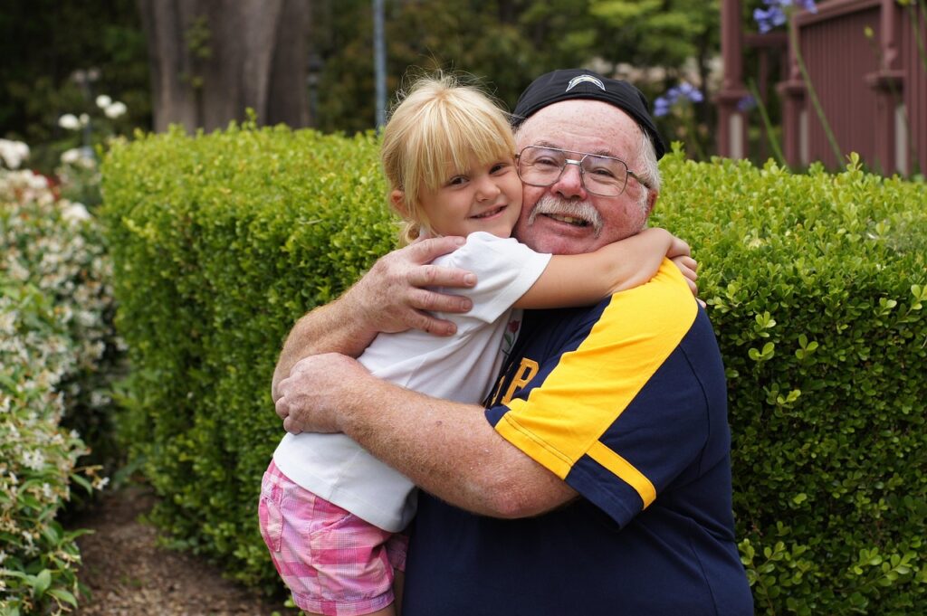 Older man hugging a child after non-invasive prostate cancer treatment