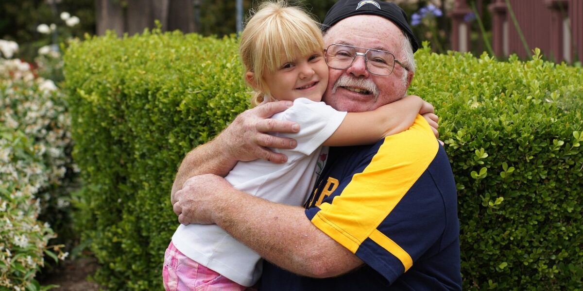 Older man hugging a child after non-invasive prostate cancer treatment
